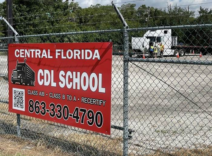 The Central Florida CDL School sign posted on the training facility fence